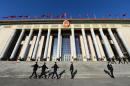 File picture shows security personnel marching past the Great Hall of the People in Beijing on March 13, 2014