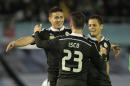 Real Madrid's James Rodriguez from Colombia left celebrates with Real Madrid's Isco and Real Madrid's Chicharito from Mexico after scoring during a Spanish La Liga soccer match between RC Celta and Real Madrid, at the Balaídos stadium in Vigo, Spain, Sunday, April 5, 2015. (AP Photo/Lalo R. Villar)