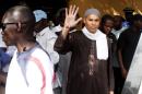 The son of former Senegalese leader Abdoulaye Wade, Karim, waves while being arrested on April 15, 2013 in Dakar