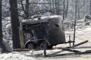 The ruins of a horse trailer destroyed by a wildfire is pictured near Conifer, Colo., on Wednesday, March 28, 2012. Two people died in the wildfire that started Monday afternoon. (AP Photo/Ed Andrieski)