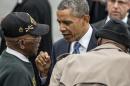 President Barack Obama talks with World War II veterans Sanders Matthews, Sr., born 1921, left, and Lewis Coffield, born 1918, both Buffalo Soldiers, at Stewart Air National Guard Base in Newburgh, N.Y., Wednesday, May 28, 2014, after delivering the commencement address at the United States Military Academy at West Point. (AP Photo/Philip Kamrass)