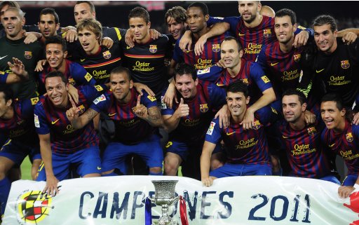 FC Barcelona players celebrate with the trophy after beating Real Madrid during their Super Cup final second leg soccer match at the Camp Nou Stadium in Barcelona, Spain, Wednesday, Aug. 17, 2011. (AP Photo/Manu Fernandez)
