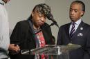 Gwen Carr, left, mother of Eric Garner, speaks as Rev. Al Sharpton looks on during a rally, Saturday, Aug. 2, 2014, in New York. The rally was held to address the medical examiner's report that came Friday saying Garner's death was caused by a chokehold, a banned police maneuver. (AP Photo/Julie Jacobson)