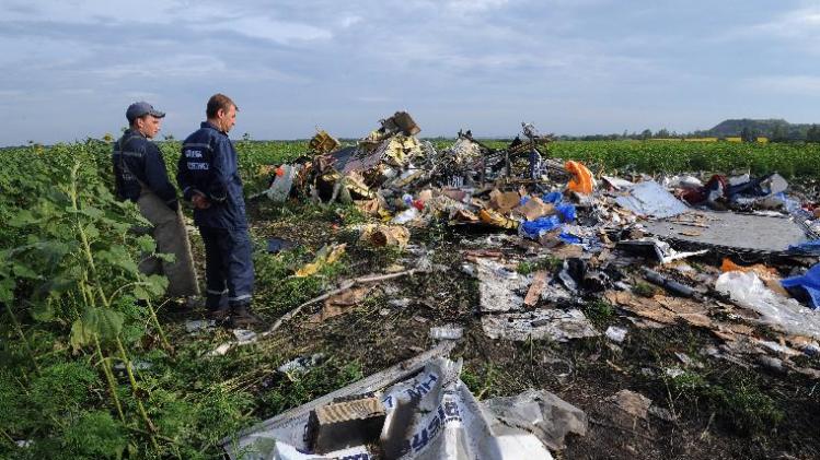 Employees of the Ukrainian State Emergency Service look at the wreckage of Malaysia Airlines flight MH17 in rebel-held east Ukraine, on July 19, 2014