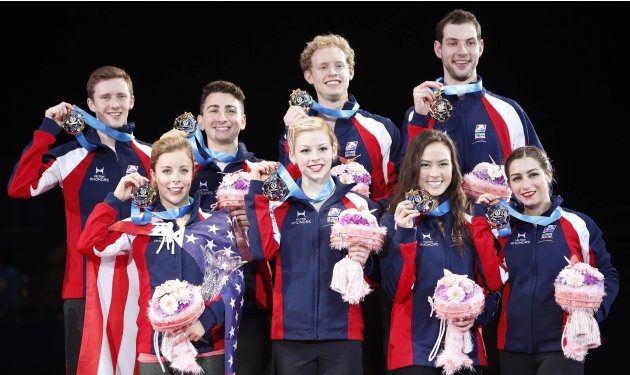 U.S. figure skaters pose with their medals on the podium at the World Team Trophy in Figure Skating in Tokyo