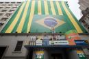 FILE - In this Sept. 24, 2010 file photo, a Brazilian flag and the word "Petrobras" decorate the entrance of the stock market building on the first day of trading in Sao Paulo, Brazil. Brazil's Attorney General Rodrigo asked the nation's Supreme Court on Tuesday, March 3, 2015 for permission to investigate top political figures for alleged involvement in a kickback scheme at the state-run oil company Petrobras, which prosecutors say is the country's largest corruption scandal yet uncovered. (AP Photo/Andre Penner, File)