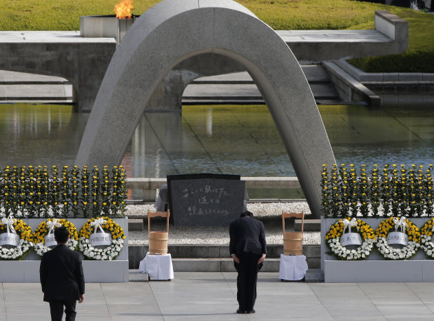 Japanese Prime Minister Yoshihiko Noda, right,  bows in front of the cenotaph for the bombing victims during the ceremony marking the 67th anniversary of the atomic bombing at Hiroshima Peace Memorial