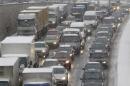 Cars and trucks are stuck in a traffic jam during a snowfall in Moscow