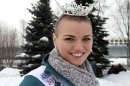 Miss Chugiak-Eagle River Debbe Ebben poses for a photo on Wednesday, March 14, 2012, in Town Square Park in Anchorage, Alaska, as a moose lies near a tree in the background . Ebben, who will compete for the title of Miss Alaska in June, had her head shaved to raise money for the St. Baldrick's Foundation, which gives grants for child cancer research. (AP Photo/Dan Joling)