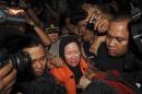 Banten governor Chosiyah, wearing an KPK orange vest, walks as she is detained at the KPK office in Jakarta