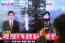 South Korean man uses his smartphone to take a television screen reporting a news about North Korea's rocket launch at Seoul Railway Station in Seoul, South Korea, Wednesday, Dec. 12, 2012. North Korea fired a long-range rocket Wednesday in its second launch under its new leader, South Korean officials said, defying warnings from the U.N. and Washington only days before South Korean presidential elections. The letters on the screen read " North Korea's rocket launch seems to be successful." (AP Photo/Ahn Young-joon)
