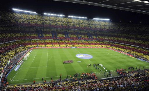 Spectators hold up cards to form a giant Catalonian flag during the Spanish first division soccer match between Barcelona and Real Madrid at Nou Camp stadium in Barcelona