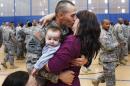Staff Sgt. Keith Fidler kisses his wife Cynthia during a homecoming ceremony in New York