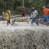 Residents cross a river with the body of a child after retrieving it from the flash flood-hit village of Andap, in New Bataan township, Compostela Valley in southern Philippines Wednesday Dec. 5, 2012, a day after the devastating Typhoon Bopha made landfall. Typhoon Bopha, one of the strongest typhoons to hit the Philippines this year, barreled across the country's south on Tuesday, killing scores of people while triggering landslides, flooding and cutting off power in two entire provinces. (AP Photo/Bullit Marquez)