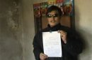 Still image taken from video shows blind legal activist Chen Guangcheng holding a petition in his village home in Linyi in eastern Shandong province