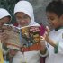 Students read a comic book with an anti-extremist theme at a primary school Friday, Sept. 9, 2011 in Jakarta, Indonesia. The real life adventures of former al-Qaida-linked terrorist Nasir Abas have become a new comic book in Indonesia, chronicling his transformation from militant to invaluable ally in the fight against terrorism. (AP Photo/Tatan Syuflana)