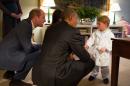 In this hand out photo released by Kensington Palace, Britain's Prince George meets with US President Barack Obama, centre and first lady Michelle Obama , at Kensington Palace, London, Friday April 22, 2016. Prince William is at left. (Pete Souza/Kensington Palace via AP)