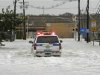 A Port Authority Police SUV makes its way through flood waters covering roads leading toward Teterboro Airport in Teterboro