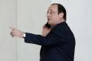 French president Francois Hollande makes a phone call at the Elysee palace on April 29, 2014 in Paris