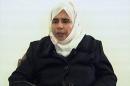 FILE - In this Nov. 13, 2005 file photo, Iraqi Sajida al-Rishawi, confesses on Jordanian state run TV about her failed bid to set off an explosives belt inside one of the three Amman hotels targeted by al-Qaida. Al-Rishawi, was sentenced to death. In January 2015, almost a decade later, she has emerged as a potential bargaining chip in negotiations over Japanese hostages held by the Islamic State group, the successor of al-Qaida in Iraq, which orchestrated the Jordan attack. (AP Photo/Jordanian TV, File)