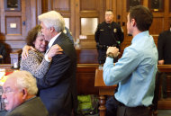 Mark Strong Sr. comforts his wife Julie after she became emotional while addressing Justice Nancy Mills during Strong's sentencing at Cumberland County Superior Court in Portland, Maine, Thursday, March 21, 2013. Strong was sentenced to 20 days in jail and a fine of $3,000 for his role in promoting a one-woman prostitution business from a Zumba studio in Kennebunk. (AP Photo/Portland Press Herald, Gregory Rec, Pool)