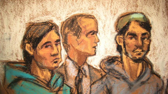 In this courtroom drawing, defendant Akhror Saidakmetov, left; an interpreter, center; and defendant Abdurasul Hasanovich Juraboev, appear at federal court in New York on terrorism charges, Wednesday, Feb. 25, 2015. Saidakmetov and Juraboev are two of the three men arrested on charges of plotting to travel to Syria to join the Islamic State group and wage war against the U.S. (AP Photo/Jane Rosenberg)