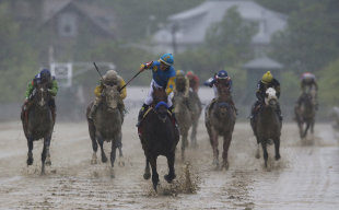 American Pharoah, ridden by Victor Espinoza, center, wins the 140th Preakness Stakes. (AP)