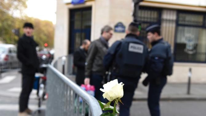 A white rose is placed on a fence close to the Bataclan theatre in the 11th district of Paris, on November 14, 2015