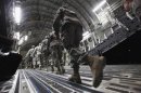 Soldiers from the 3rd Brigade, 1st Cavalry Division board a C-17 transport plane to depart from Iraq at Camp Adder