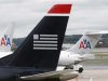 A US Airways plane and American Airlines planes share a terminal at Ronald Reagan National Airport in Washington