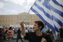 An anti-austerity protester holds a Greek flag during a rally in Athens
