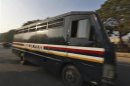A police van carrying five men accused of the gang rape and murder of an Indian student leaves a court in New Delhi