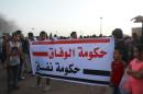 People carry a banner during a protest against candidates for a national unity government proposed by U.N. envoy for Libya Bernardino Leon, in Benghazi
