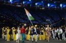 India's Sushil Kumar waves the flag at the opening ceremonies on July 27. To his left, in red, is a mystery gatecrasher