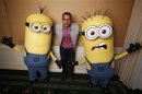 Carell poses with two life-size minion characters while promoting his upcoming movie "Despicable Me 2" in Los Angeles