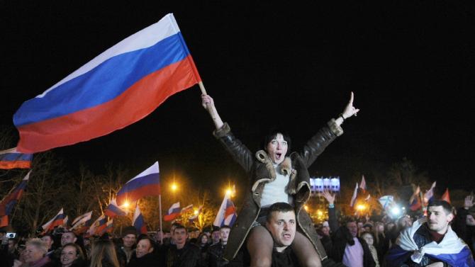 Pro-Russian Crimeans celebrate in Sevastopol after partial results showed that about 95.5 percent of voters in Ukraine&#39;s Crimea region supported union with Russia