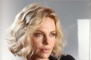 FILE - In this Dec. 9, 2011 file photo, actress Charlize Theron poses for a portrait in New York. Theron's publicist told The Associated Press, Wednesday, March 14, 2012, that the actress is the mother of an adopted healthy baby boy named Jackson. No other details were provided. (AP Photo/Carlo Allegri, file)