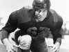 FILE - In this Dec. 4, 1951, file photo, football player Les Richter poses for a picture in California. Richter, who died in June 2010, will be inducted posthumously into the Pro Football Hall of Fame this weekend. Richter was an imposing figure at 6-foot-3 and almost 240 lbs., size that made him one of the most physical linebackers in the NFL and earned him the nickname "Dirty Les" for his aggressive play. (AP Photo/File)