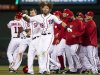 Washington Nationals right fielder Jayson Werth (28) escapes from his teammates after being rushed for hitting the game-winning single during the 13th inning of a baseball game against the Cincinnati Reds on Friday, April 13, 2012, in Washington. The Nationals won 2-1. (AP Photo/Evan Vucci)