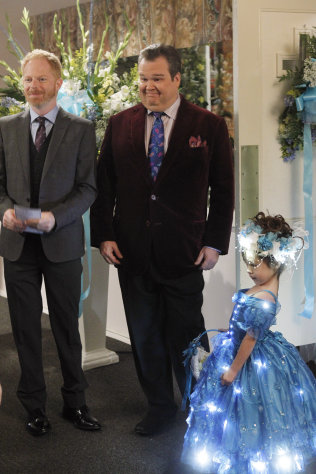 In this image released by ABC, from left, Jesse Tyler Ferguson portraying Mitchell Pritchett, and Eric Stonestreet portraying Cameron Tucker are shown with Aubrey Anderson-Emmons, who plays their adopted daughter Lily in a scene from "Modern Family," airing Wednesday, Jan. 18, 2012 at 9 p.m. EST on ABC. A group opposed to the use of profanity is protesting Wednesday's episode of "Modern Family," in which the character Lily is shown, but not heard, using an expletive. (AP Photo/ABC, Peter "Hopper" Stone)