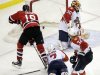 New Jersey Devils' Travis Zajac (19) scores the game-winning goal on Florida Panthers goalie Scott Clemmensen (30) as Dmitry Kulikov (7), of Russia, and Kris Versteeg (32) defend during the overtime of Game 6 of a first-round NHL hockey Stanley Cup playoff series, Tuesday, April 24, 2012, in Newark, N.J. The Devils won 3-2, forcing Game 7. (AP Photo/Julio Cortez)
