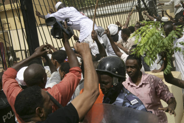 Sudanese protesters and riot police face off during a protest outside the German embassy in Khartoum, Sudan, Friday, Sept. 14, 2012, as part of widespread anger across the Muslim world about a film ridiculing Islam's Prophet Muhammad. Germany's Foreign Minister says the country's embassy in the Sudanese capital of Khartoum has been stormed by protesters and set partially on fire. Minister Guido Westerwelle told reporters that the demonstrators are apparently protesting against an anti-Islam film produced in the United States that denigrates the Prophet Muhammad.(AP Photo/Abd Raouf)