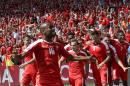 Switzerland's Xherdan Shaqiri, center, celebrates after scoring his side's first goal during the Euro 2016 round of 16 soccer match between Switzerland and Poland, at the Geoffroy Guichard stadium in Saint-Etienne, France, Saturday, June 25, 2016. (AP Photo/Pavel Golovkin)