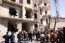 This photo released by the Syrian official news agency SANA shows Syrian rescue teams investigating the scene after an explosion in Aleppo, Syria, Sunday, March 18, 2012. An explosion ripped through a residential neighborhood in the northern Syrian city of Aleppo on Sunday and the state news agency said it was a 
