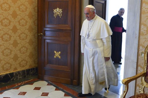 Pope Francis walks to meet U.N. Secretary-General Ban Ki-moon during a meeting at the Vatican