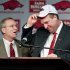 Arkansas athletic director Jeff Long, left, presents Bret Bielema with a cap as Bielema is introduced as the school's new head coach during an NCAA college football news conference in Fayetteville, Ark., Wednesday, Dec. 5, 2012. Bielema, who will be paid $3.2 million annually for six years, replaces interim coach John L. Smith, who was hired after Bobby Petrino was fired in April. (AP Photo/April L. Brown)