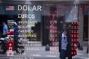 A sign shows no currency exchange numbers outside a money exchange house in Buenos Aires, Argentina, Friday, Jan. 24, 2014. An employee at the business said they were not operating until they received official rules from the government, which announced a relaxing of restrictions on the purchase of U.S. dollars following a sharp slide in the value of the local peso. (AP Photo/Natacha Pisarenko)