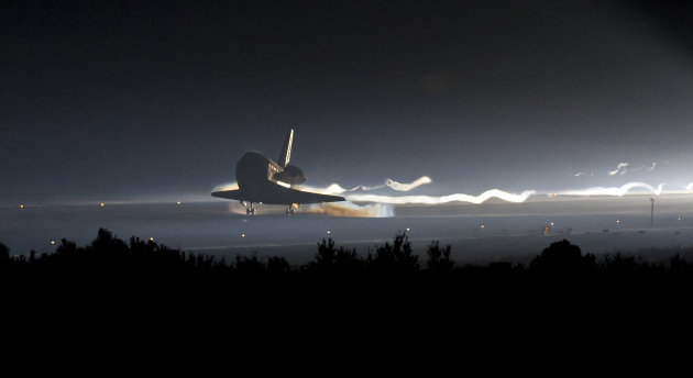 In this image provided by NASA, Space Shuttle Atlantis touches down at NASA's Kennedy Space Center Shuttle Landing Facility in Cape Canaveral, Fla., completing its 13-day mission to the International Space Station and the final flight of the Space Shuttle Program, early Thursday morning, July 21, 2011. Atlantis, the fourth orbiter built, launched on its first mission on Oct. 3, 1985. (AP Photo/NASA - Bill Ingalls)