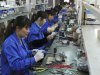Employees make circuit boards at an electronic component factory in Hefei
