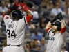 Boston Red Sox's Napoli celebrates his grand slam home run with teammate Ortiz against the New York Yankees during the third inning of their MLB American League baseball game at Yankee Stadium